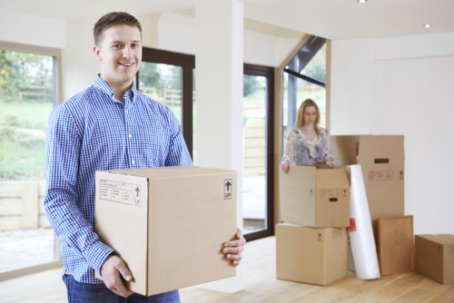 Trained movers lifting furniture with care in Stockwell